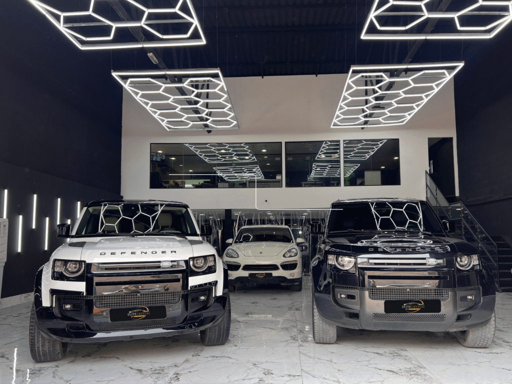 Two Defenders and one Porche at Elite Crystal Car Care Dubai for PPF Ceramic Coating and Car Detailing